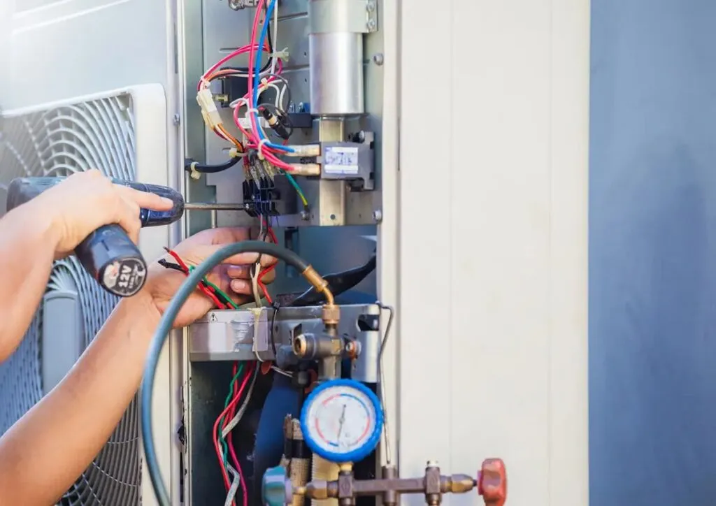 AC repair Sarasota technician servicing outdoor unit