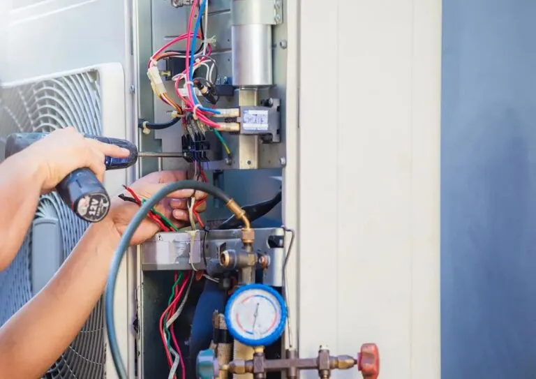 AC repair Sarasota technician servicing outdoor unit