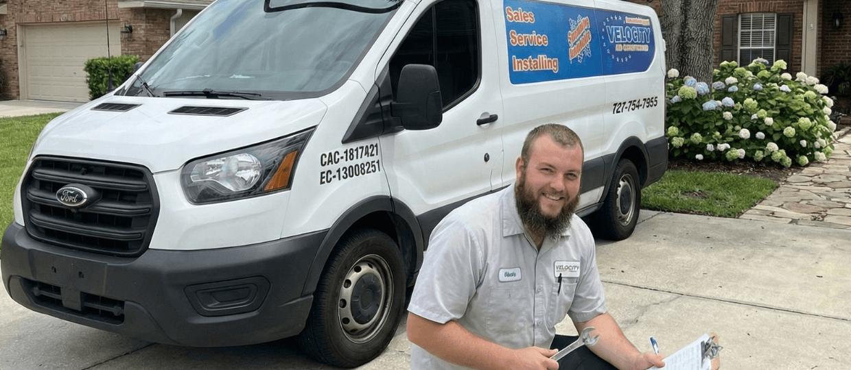 Velocity Air Conditioning technician inspecting HVAC equipment