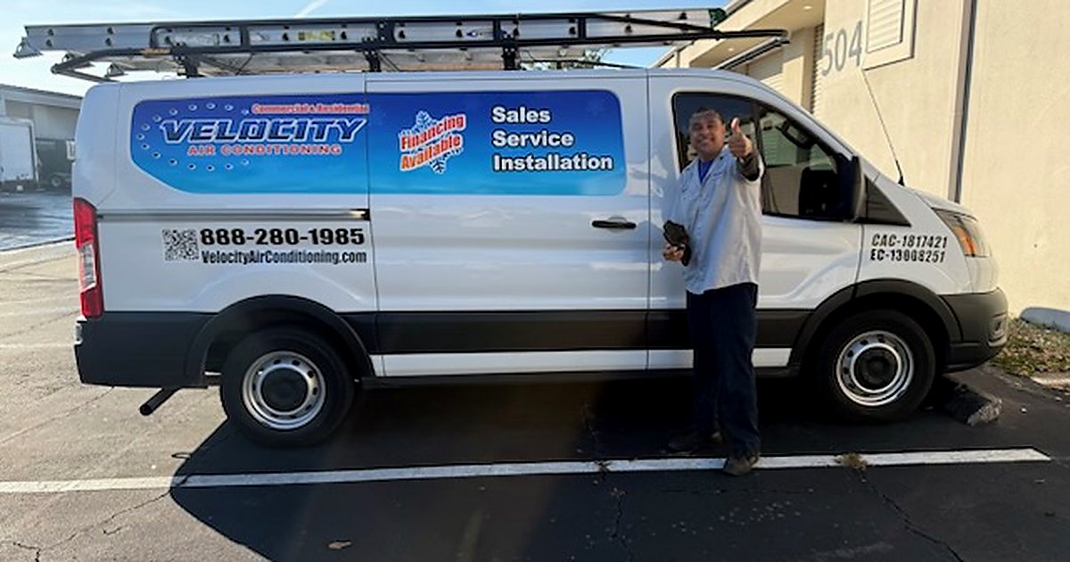 Velocity Air Conditioning technician inspecting HVAC equipment