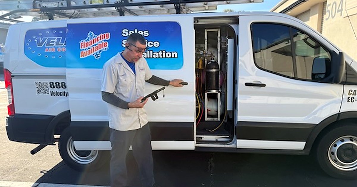 Velocity Air Conditioning technician inspecting HVAC equipment