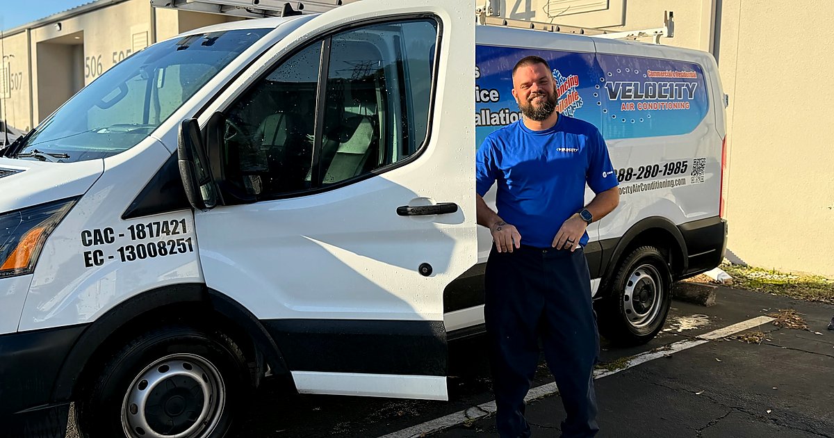 Velocity Air Conditioning technician inspecting HVAC equipment
