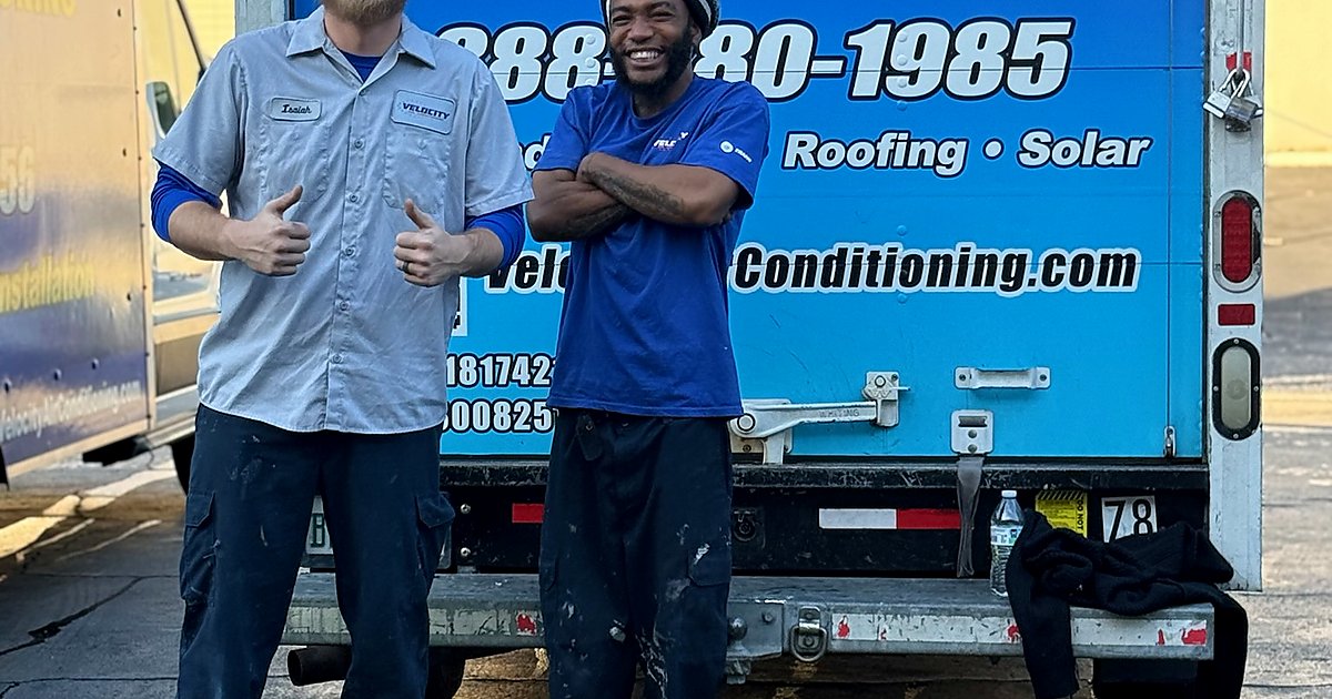 Velocity Air Conditioning technician inspecting a residential HVAC condenser in Lee County