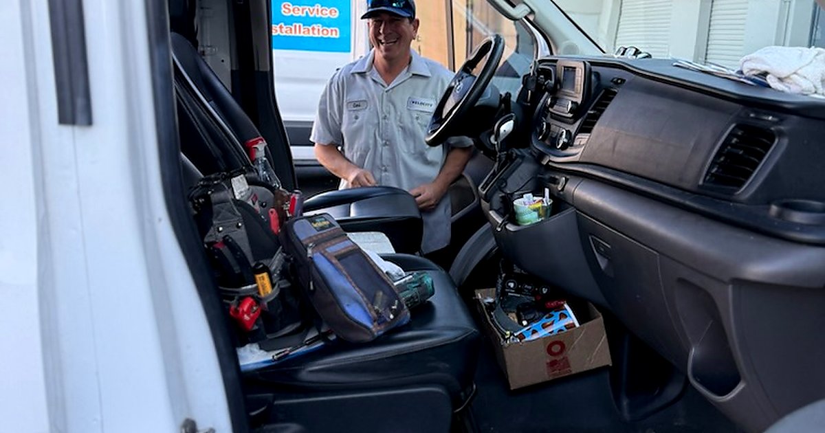 Velocity Air Conditioning technician inspecting HVAC equipment